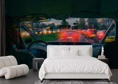 Driving a car in the city at night in traffic jams Wall mural