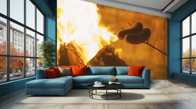 Roasting sausages on the campfire Wall mural