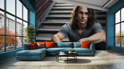 Long haired young man sitting on some stairs. generate by ai Wall mural