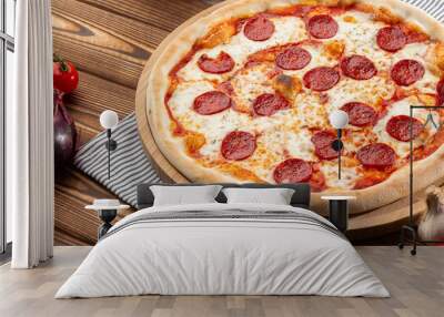 Delicious hot homemade Pepperoni pizza on the wooden table. Pepperoni Pizza - Fresh homemade pizza with pepperoni, cheese and tomato sauce on rustic black stone background wirh copy space.   Wall mural