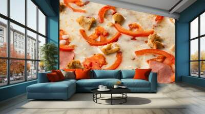 Flat lay with traditional Italian pizza with chicken, ham, cheese and tomatoes on wooden  back. Wall mural