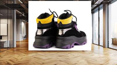 Women's black, purple and yellow hiking boots isolated white background. Back side view. Fashion shoes. Photoshoot for shoe shop concept. Wall mural