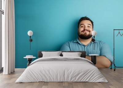 portrait of a handsome smiling brunette man dressed casual, isolated on blue background; copy space Wall mural