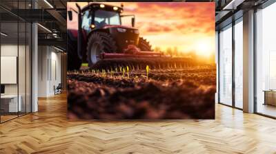 tractor working in field during sunrise; concept of agricultural work, farm, equipment; copy space Wall mural