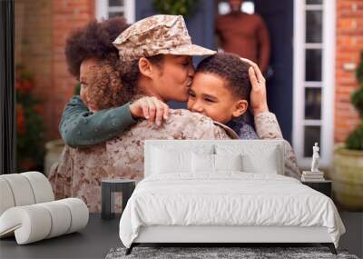 American Female Soldier In Uniform Returning Home To Family On Hugging Children Outside House Wall mural