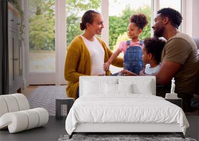 Army Family With Pregnant Mother Sitting On Floor In Lounge At Home Wall mural