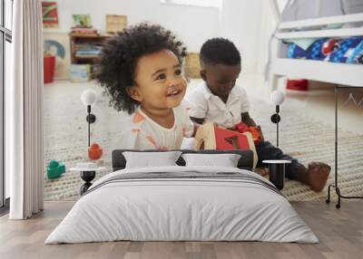 Baby Boy And Girl Playing With Toys In Playroom Together Wall mural