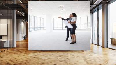 Businesspeople Meeting To Look At Plans In Empty Office Wall mural