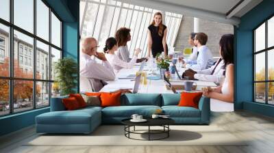 Caucasian Businesswoman Leading Meeting At Boardroom Table Wall mural