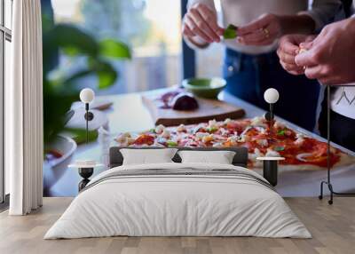 Close Up Of Couple In Kitchen At Home Making Homemade Pizza Together Wall mural