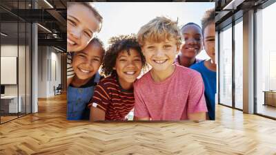 Close up of pre-teen friends in a park smiling to camera Wall mural