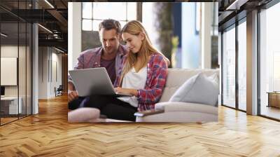 couple at home in lounge using laptop computer Wall mural