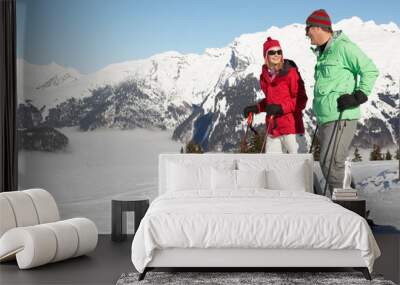 Couple Having Fun On Ski Holiday In Mountains Wall mural