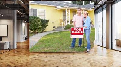 couple standing by for sale sign outside home Wall mural