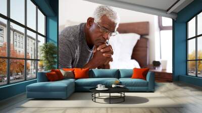 Depressed Senior Man Looking Unhappy Sitting On Side Of Bed At Home With Head In Hands Wall mural