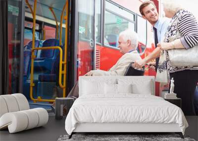 Driver Helping Senior Couple Board Bus Via Wheelchair Ramp Wall mural