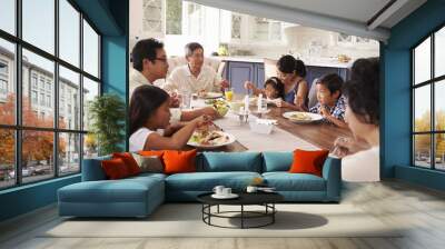 extended family group eating meal at home together Wall mural