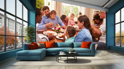 family and friends sitting at a dining table Wall mural