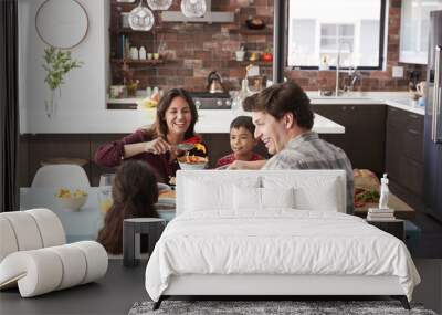 Family Enjoying Meal Around Table At Home Together Wall mural