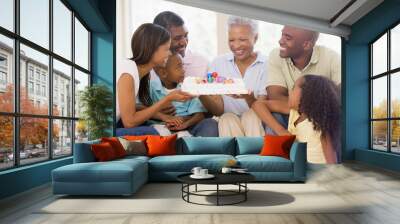 Family in living room with cake smiling Wall mural