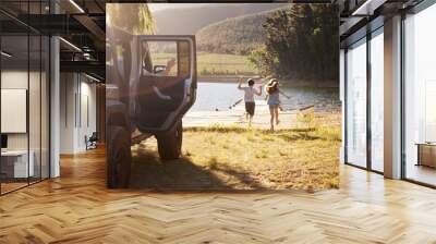 Family Reaching Destination By Lake After Road Trip Wall mural