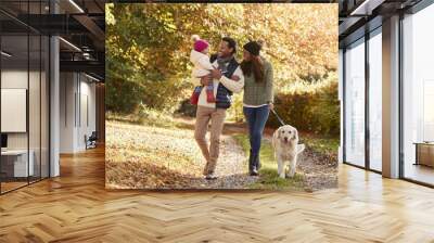 Family With Daughter And Dog Enjoy Autumn Countryside Walk Wall mural