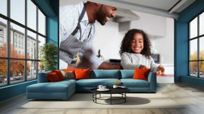 Father And Daughter In Kitchen At Home Making Pancakes Together Wall mural