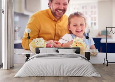 Father And Daughter In Kitchen Decorating Ice Cream Dessert With Cream And Sprinkles Wall mural