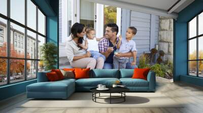 Father Giving Children Candy On Steps Outside Hose Wall mural