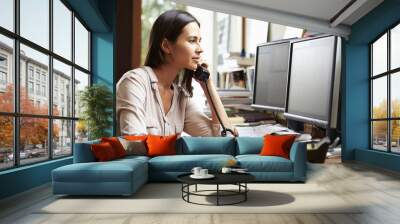 female architect working at desk on computer Wall mural