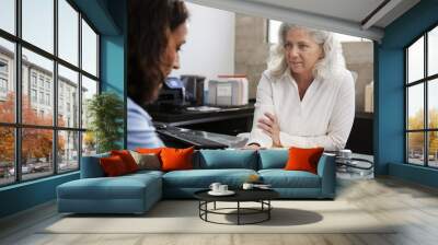 Female doctor reassuring a patient in consultation Wall mural