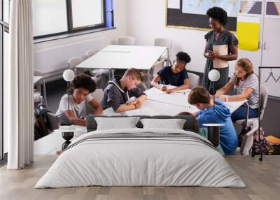 Female High School Tutor Standing By Table With Students Teaching Lesson Wall mural