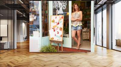 female owner of delicatessen standing outside shop Wall mural