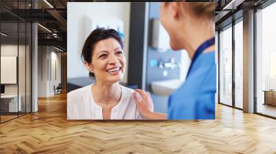 Female Patient Being Reassured By Doctor In Hospital Room Wall mural