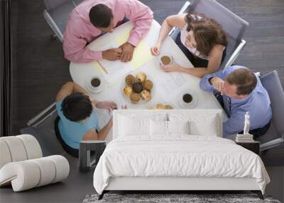 four businesspeople at boardroom table with breakfast Wall mural