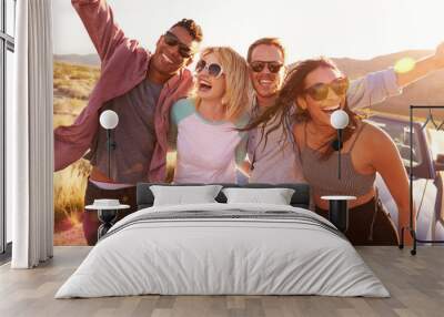 Friends On Road Trip Sitting On Hood Of Convertible Car Wall mural