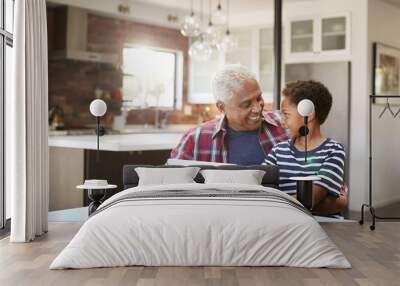 Grandfather And Grandson Sitting Around Table At Home Using Laptop Together Wall mural