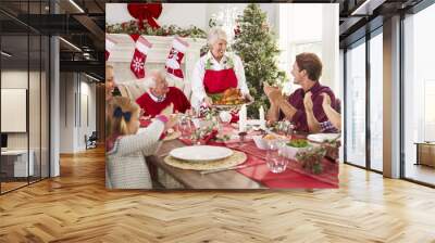 Grandmother Bringing Out Turkey At Family Christmas Meal Wall mural