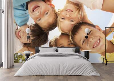 group of children looking down into camera Wall mural