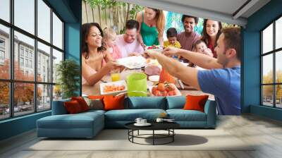 Group Of Families Enjoying Outdoor Meal At Home Wall mural