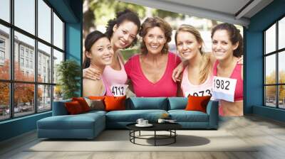 group of female athletes competing in charity marathon race Wall mural