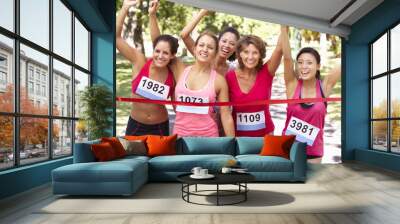 Group Of Female Athletes Completing  Charity Marathon Race Wall mural