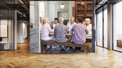 Group Of Friends Enjoying Meal At Home Together Wall mural