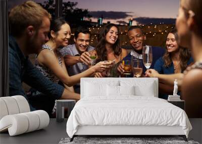 Group Of Friends Enjoying Night Out At Rooftop Bar Wall mural