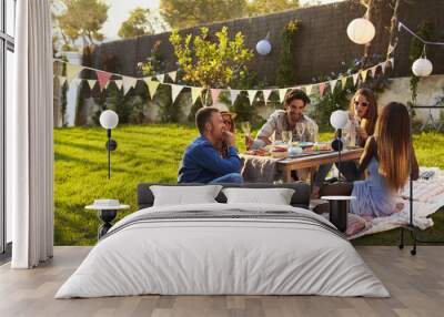 Group Of Friends Enjoying Outdoor Picnic In Garden Wall mural