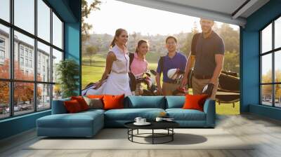 Group Of Golfers Walking Along Fairway Carrying Golf Bags Wall mural