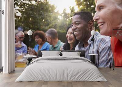 Group Of Mature Friends Enjoying Outdoor Meal In Backyard Wall mural