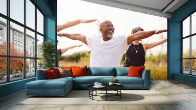 Group Of Mature Men And Women In Class At Outdoor Yoga Retreat Wall mural