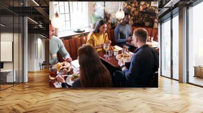 Group Of People Eating In Restaurant Of Busy Traditional English Pub Wall mural