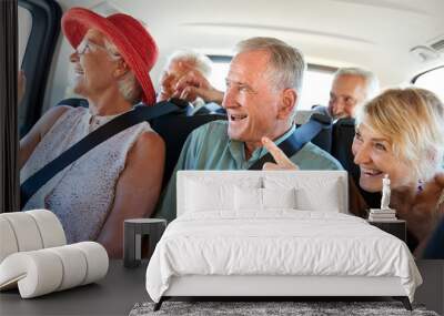 Group Of Senior Friends Sitting In Back Of Van Being Driven To Vacation Wall mural